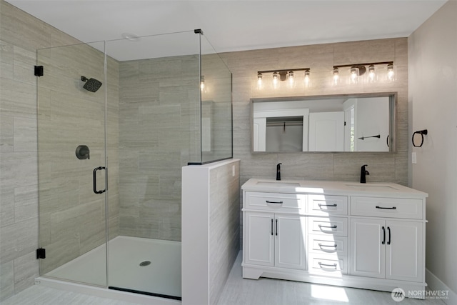 5020 Gold Ridge Ln SW, Olympia, WA 98512 - bathroom featuring tile walls, a shower stall, double vanity, and tile patterned flooring