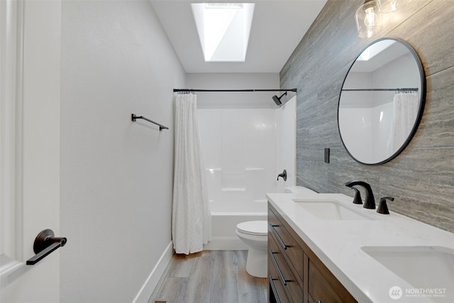 5020 Gold Ridge Ln SW, Olympia, WA 98512 - full bathroom featuring double vanity, a skylight, wood finished floors, toilet, and shower / bath combo