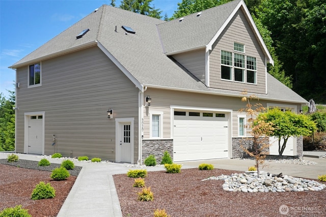 5020 Gold Ridge Ln SW, Olympia, WA 98512 - craftsman house with a shingled roof, stone siding, and a garage