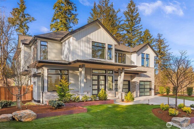 21412 NE 16th St, Sammamish, WA 98074 - view of front of home with driveway, a garage, and stone siding