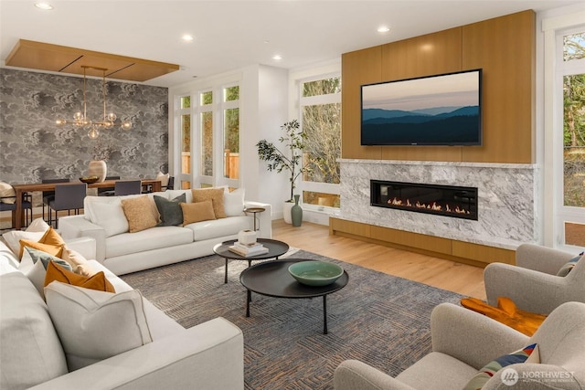 21412 NE 16th St, Sammamish, WA 98074 - living room with wood finished floors, healthy amount of natural light, a chandelier, a fireplace, and recessed lighting