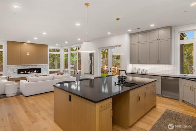 21412 NE 16th St, Sammamish, WA 98074 - kitchen featuring a sink, dishwasher, dark countertops, backsplash, and open floor plan