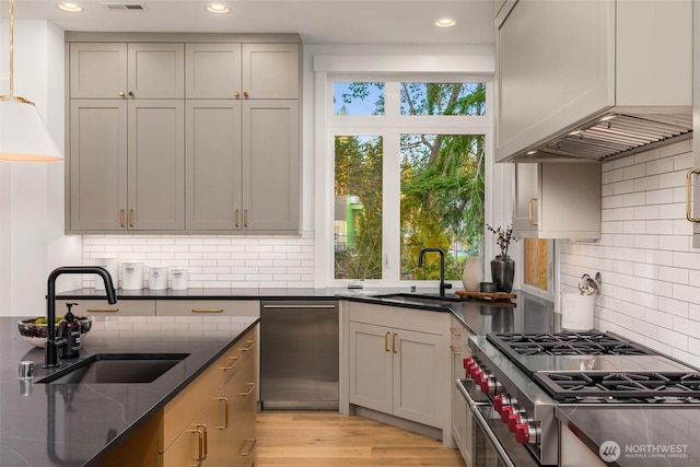 21412 NE 16th St, Sammamish, WA 98074 - kitchen featuring appliances with stainless steel finishes, a sink, tasteful backsplash, premium range hood, and recessed lighting