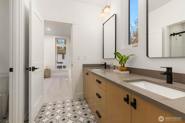 21412 NE 16th St, Sammamish, WA 98074 - bathroom featuring double vanity, baseboards, and toilet