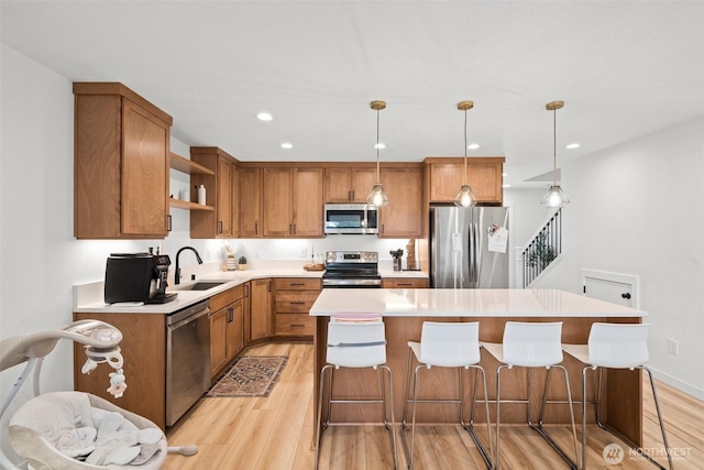 1013 Peach Rd Unit A & B, Winlock, WA 98659 - kitchen with stainless steel appliances, a sink, open shelves, light wood-style floors, and a kitchen island