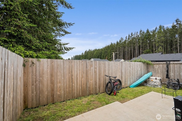 1013 Peach Rd Unit A & B, Winlock, WA 98659 - fenced backyard with a patio area and a wooded view