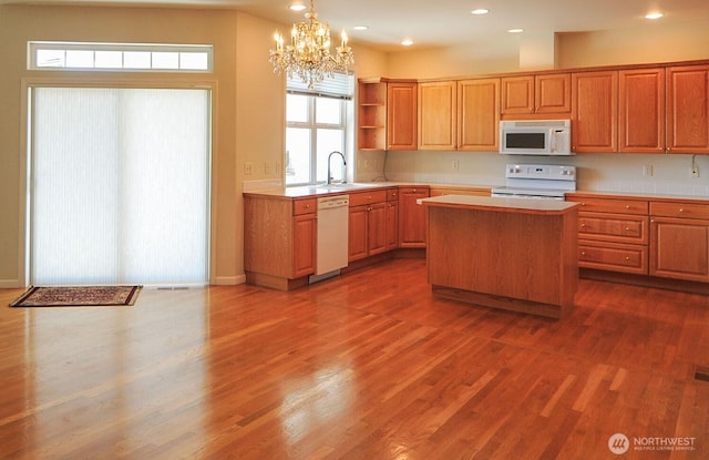 1494 Eastmont Ave Unit 58, East Wenatchee, WA 98802 - kitchen with white appliances, open shelves, a chandelier, light countertops, and a kitchen island