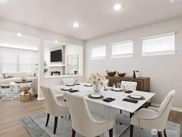 768 SE 11th Pl Lot 05, North Bend, WA 98045 - dining room with wood finished floors, healthy amount of natural light, a glass covered fireplace, baseboards, and recessed lighting