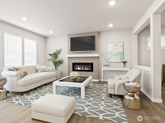 768 SE 11th Pl Lot 05, North Bend, WA 98045 - living room with wood finished floors, a glass covered fireplace, recessed lighting, and baseboards