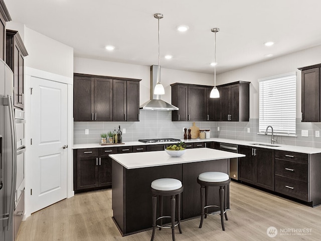 768 SE 11th Pl Lot 05, North Bend, WA 98045 - kitchen with wall chimney exhaust hood, a sink, a kitchen island, tasteful backsplash, and recessed lighting