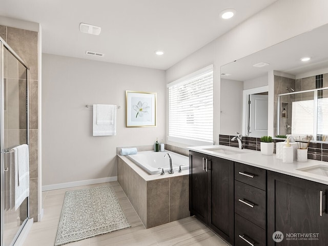 768 SE 11th Pl Lot 05, North Bend, WA 98045 - bathroom featuring a shower stall, a garden tub, double vanity, baseboards, and recessed lighting