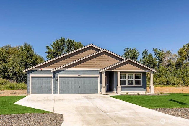 716 SE 11th Pl Unit 7, North Bend, WA 98045 - view of front facade featuring a front yard, driveway, and an attached garage