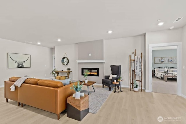 716 SE 11th Pl Unit 7, North Bend, WA 98045 - living room with wood finished floors, a glass covered fireplace, recessed lighting, and baseboards