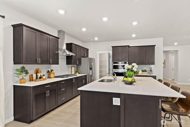 716 SE 11th Pl Unit 7, North Bend, WA 98045 - kitchen with wall chimney exhaust hood, a sink, stainless steel appliances, tasteful backsplash, and recessed lighting