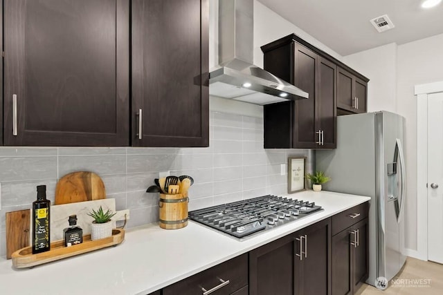 716 SE 11th Pl Unit 7, North Bend, WA 98045 - kitchen with wall chimney exhaust hood, appliances with stainless steel finishes, decorative backsplash, and light countertops