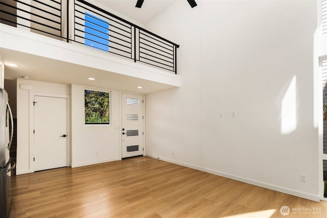 6320 41st Ave SW Unit D, Seattle, WA 98136 - foyer featuring light wood-type flooring, baseboards, a ceiling fan, a towering ceiling, and recessed lighting