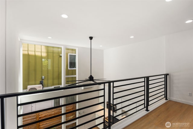 6320 41st Ave SW Unit D, Seattle, WA 98136 - corridor with wood finished floors, recessed lighting, baseboards, and an upstairs landing