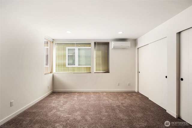 6320 41st Ave SW Unit D, Seattle, WA 98136 - unfurnished bedroom with carpet, a wall unit AC, baseboards, recessed lighting, and two closets