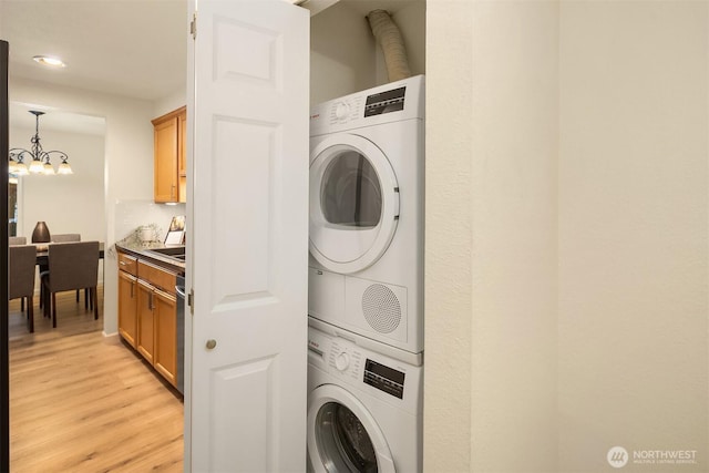 12223 NE Bel-Red Rd Unit D105, Bellevue, WA 98005 - laundry room featuring estacked washer and dryer, a chandelier, light wood-style floors, and recessed lighting