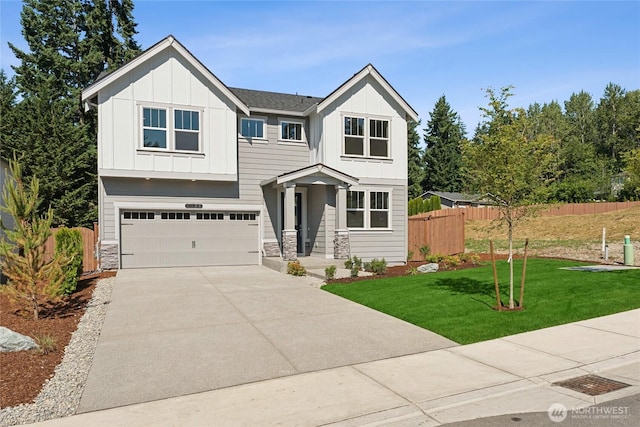 3822 98th Avenue Ct E Unit 9, Edgewood, WA 98371 - view of front of house with board and batten siding, a garage, concrete driveway, and stone siding