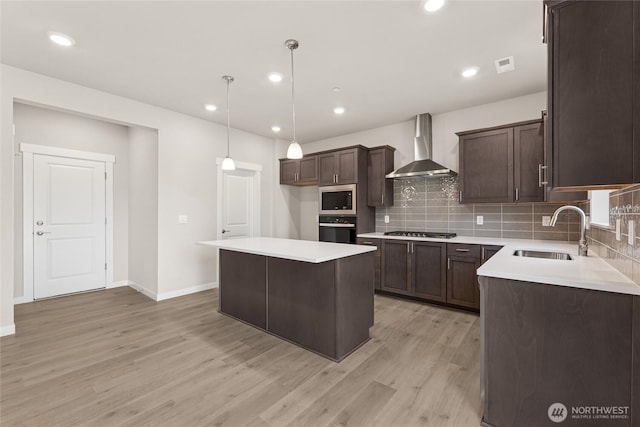 3822 98th Avenue Ct E Unit 9, Edgewood, WA 98371 - kitchen with wall chimney range hood, black oven, stainless steel microwave, light wood-type flooring, and dark brown cabinetry