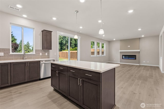 3822 98th Avenue Ct E Unit 9, Edgewood, WA 98371 - kitchen featuring dishwasher, light wood-style floors, light countertops, dark brown cabinetry, and recessed lighting