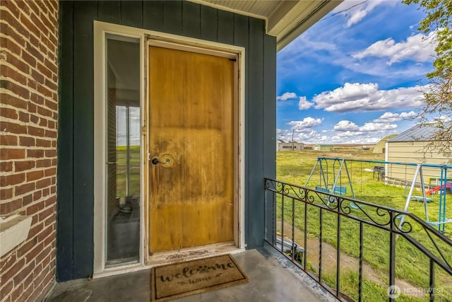 8495 Williams Rd E, Wilbur, WA 99185 - entrance to property featuring board and batten siding, brick siding, and a yard