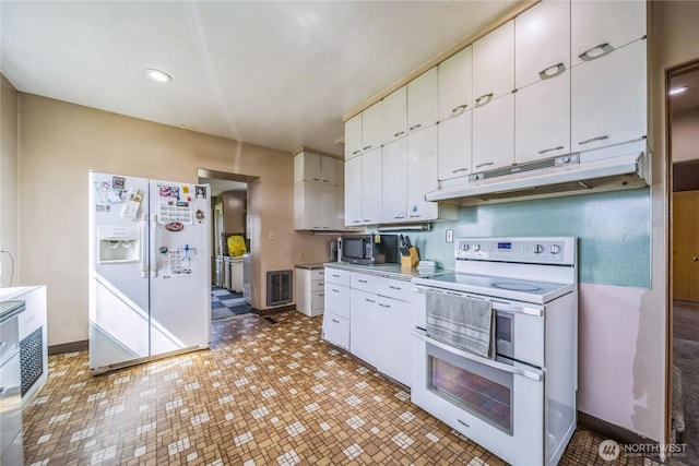 8495 Williams Rd E, Wilbur, WA 99185 - kitchen featuring white appliances, under cabinet range hood, white cabinets, baseboards, and light countertops