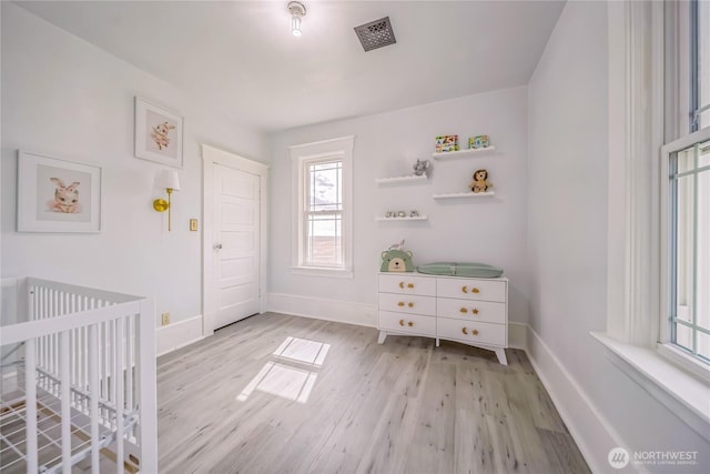 8495 Williams Rd E, Wilbur, WA 99185 - bedroom featuring wood finished floors, baseboards, and a crib