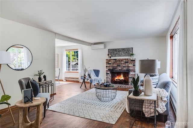 11816 40th Ave S, Tukwila, WA 98168 - living room featuring a wall unit AC, a fireplace, wood finished floors, and baseboard heating
