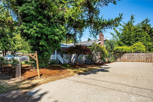 11816 40th Ave S, Tukwila, WA 98168 - view of front of house featuring a chimney, covered porch, and driveway