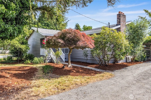 11816 40th Ave S, Tukwila, WA 98168 - view of property hidden behind natural elements featuring a chimney