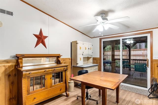 40 E Olde Lyme Rd, Shelton, WA 98584 - dining space featuring ceiling fan, crown molding, light wood-style flooring, wainscoting, and a textured ceiling