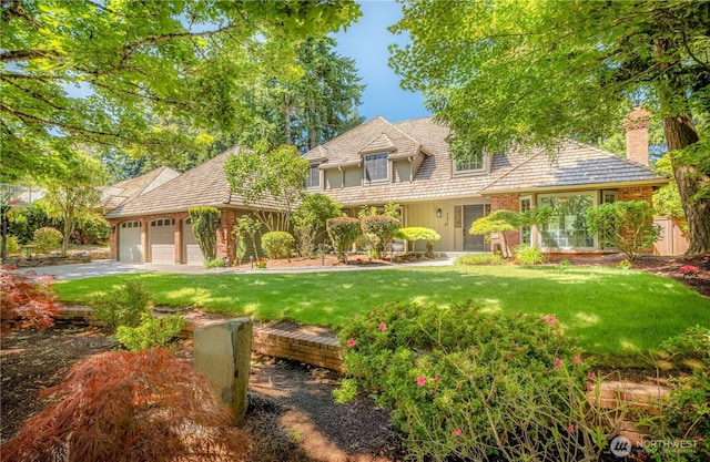 7375 80th Pl SE, Mercer Island, WA 98040 - view of front of home featuring a front yard, an attached garage, a chimney, driveway, and brick siding