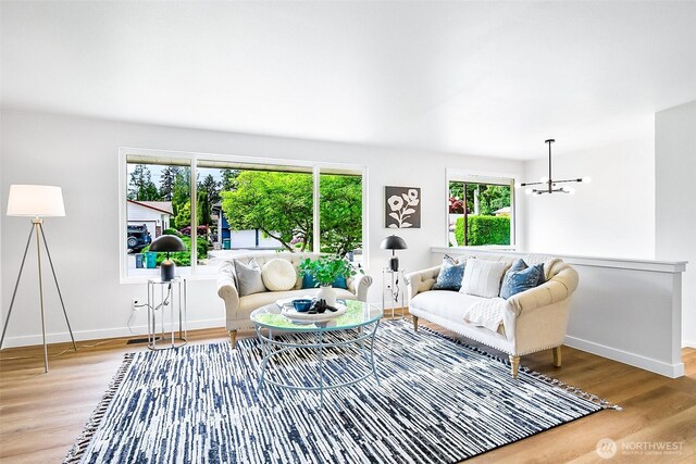 1231 121st Pl SE, Everett, WA 98208 - living area featuring wood finished floors, baseboards, and a chandelier