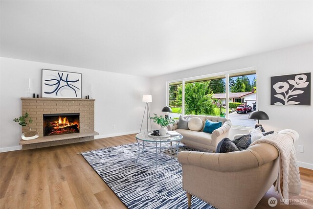 1231 121st Pl SE, Everett, WA 98208 - living area with a brick fireplace, wood finished floors, and baseboards