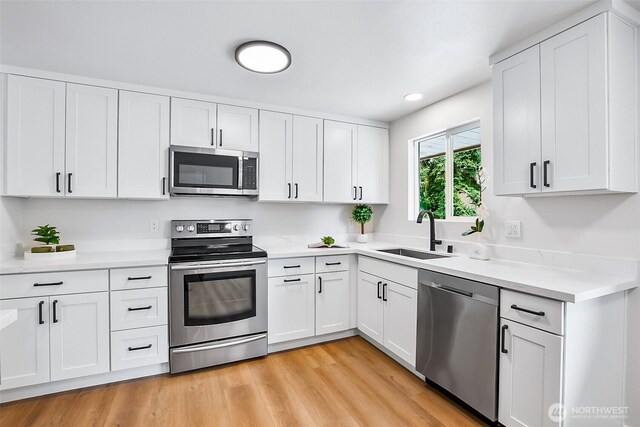 1231 121st Pl SE, Everett, WA 98208 - kitchen with stainless steel appliances, a sink, light countertops, white cabinetry, and recessed lighting