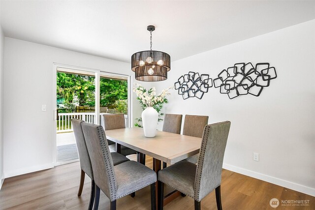 1231 121st Pl SE, Everett, WA 98208 - dining area with a chandelier, wood finished floors, and baseboards
