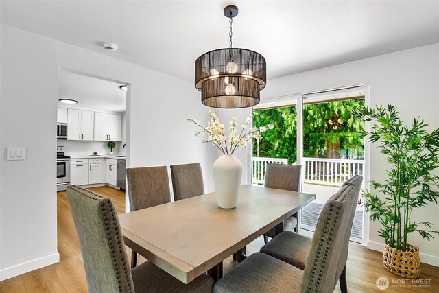 1231 121st Pl SE, Everett, WA 98208 - dining area with light wood-style floors, baseboards, and a chandelier