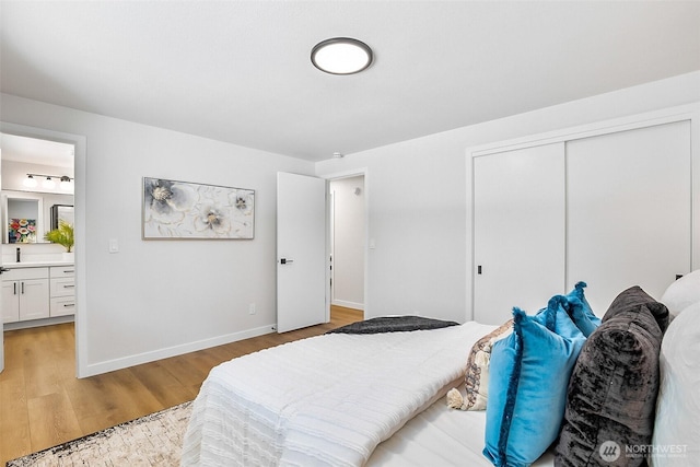 1231 121st Pl SE, Everett, WA 98208 - bedroom with a closet, light wood-style floors, baseboards, and ensuite bath
