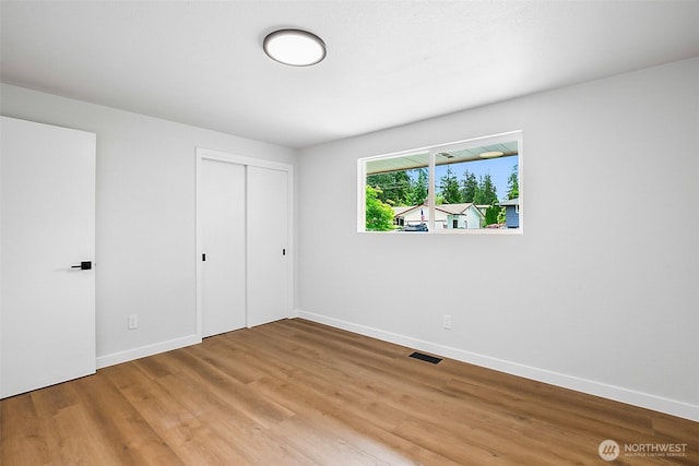 1231 121st Pl SE, Everett, WA 98208 - unfurnished bedroom featuring baseboards, light wood-style flooring, and a closet