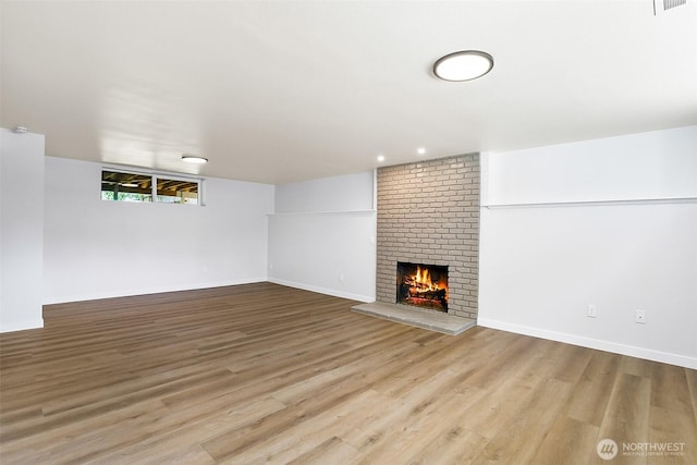 1231 121st Pl SE, Everett, WA 98208 - unfurnished living room with a fireplace, wood finished floors, and baseboards
