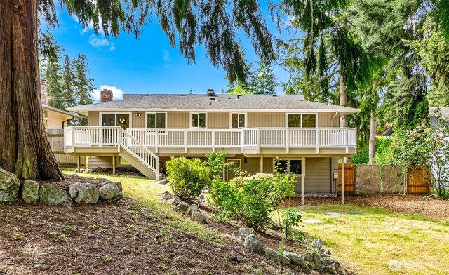 1231 121st Pl SE, Everett, WA 98208 - back of house featuring a wooden deck, a chimney, stairway, board and batten siding, and roof with shingles