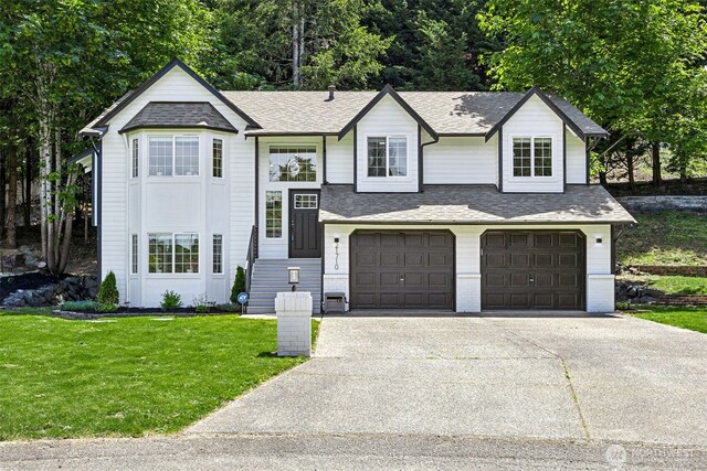 21710 104th Ave E, Graham, WA 98338 - view of front of home with a garage, concrete driveway, a front lawn, and roof with shingles