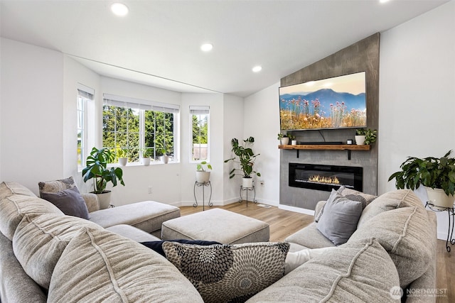 21710 104th Ave E, Graham, WA 98338 - living room featuring recessed lighting, light wood-type flooring, a large fireplace, and baseboards