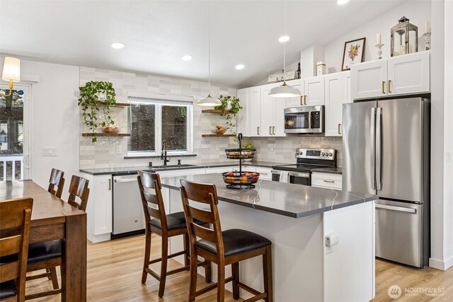 21710 104th Ave E, Graham, WA 98338 - kitchen with stainless steel appliances, open shelves, a sink, dark countertops, and recessed lighting