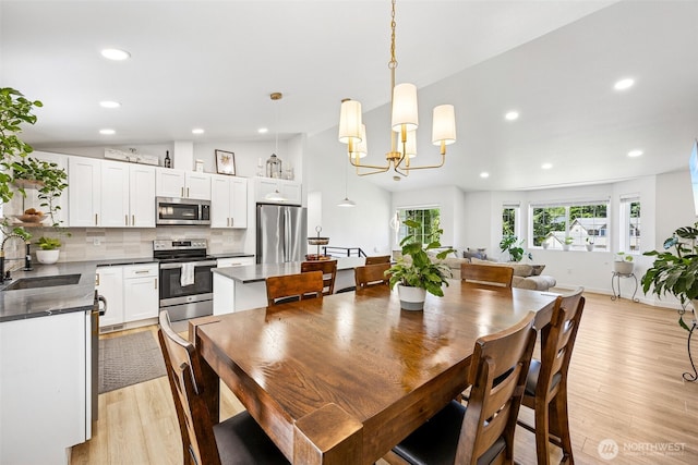 21710 104th Ave E, Graham, WA 98338 - dining space featuring light wood-type flooring, recessed lighting, a chandelier, and lofted ceiling