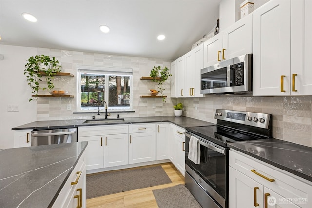 21710 104th Ave E, Graham, WA 98338 - kitchen with appliances with stainless steel finishes, a sink, open shelves, dark countertops, and recessed lighting