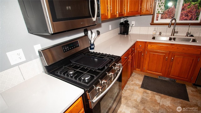 161 E Connemara Way, Shelton, WA 98584 - kitchen featuring stainless steel appliances, a sink, brown cabinets, and light countertops