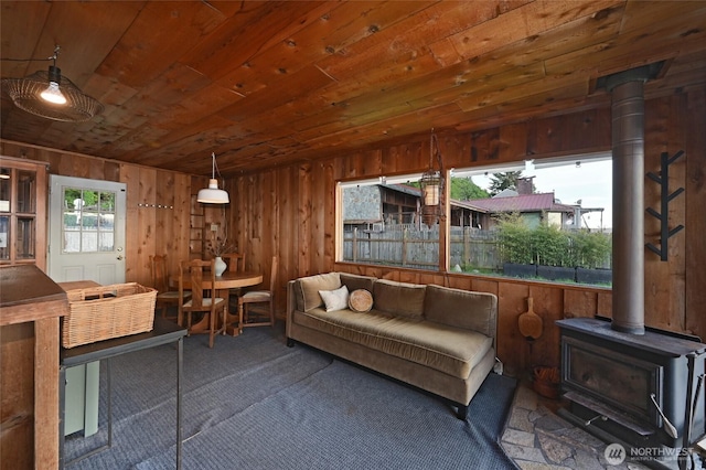 8204 Naketa Beach Walk, Mukilteo, WA 98275 - carpeted living room with a wood stove, wood walls, and wood ceiling
